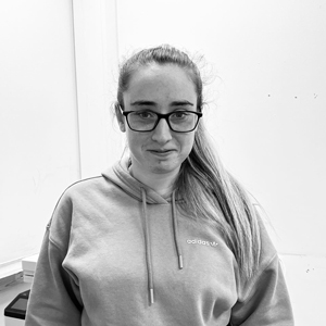 woman with glasses and a septum piercing sitting in a car image showing confidence and style related to 18 years older