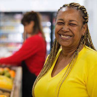 smiling woman wearing yellow shirt in grocery store with colorful fruits and vegetables fresh produce healthy lifestyle three options